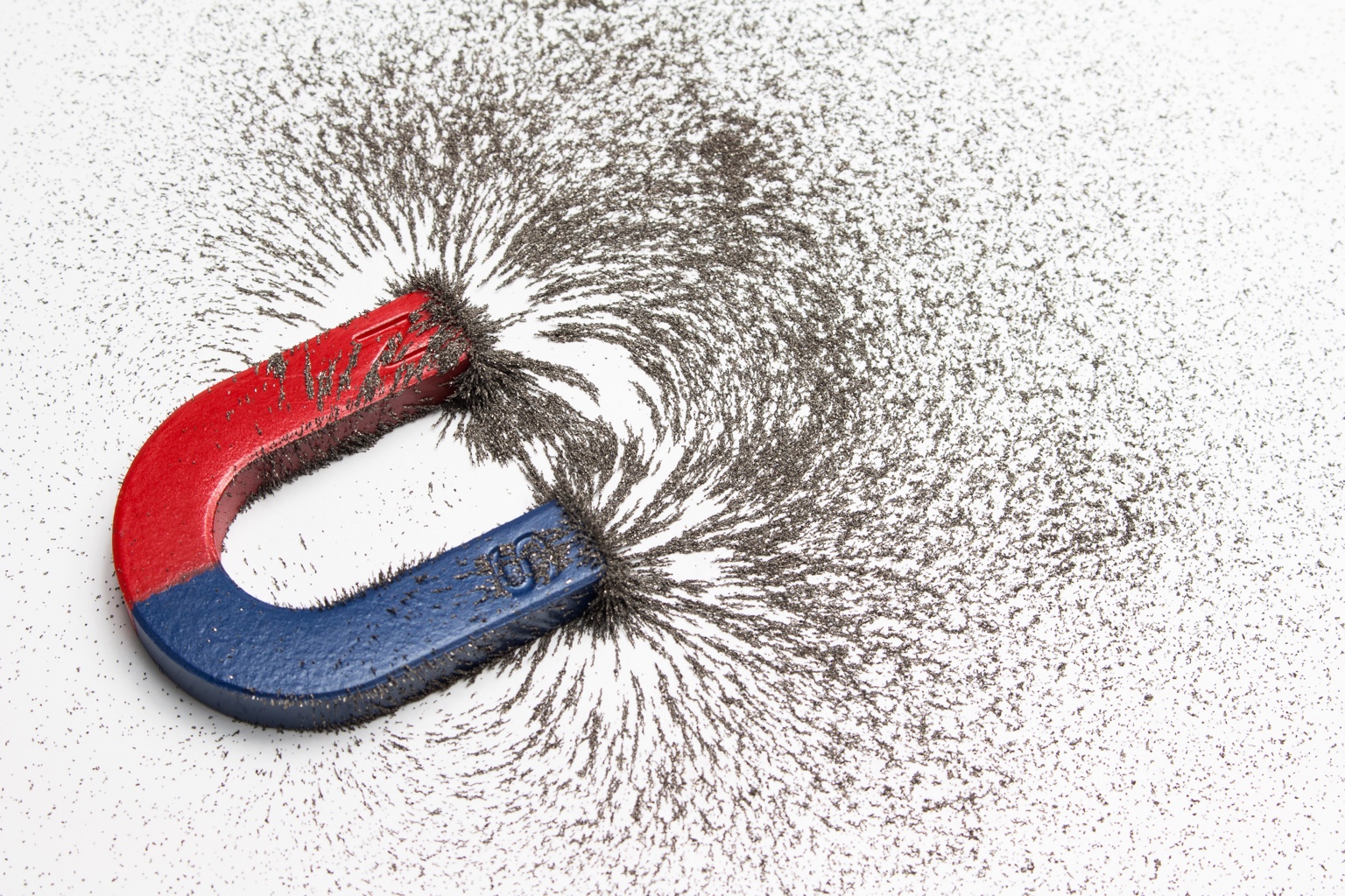 Hufeisenmagnet zieht Eisenspäne an – Symbol für Kunden gewinnen durch gezieltes Pull-Marketing